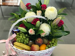 Fruits, treats and flowers basket