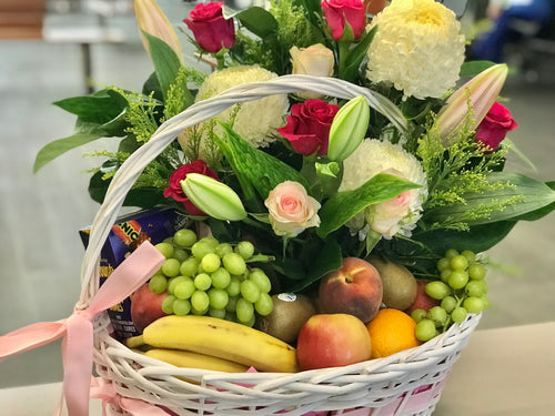 Fruits, treats and flowers basket