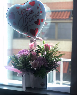 “ You are loved “ balloon and flowers